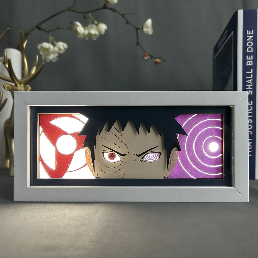 <img src="obito-uchiha.jpg" alt="Obito Uchiha LED art frame featuring the iconic dual eye powers with the Sharingan and Rinnegan. The vibrant red and purple background accents highlight Obito's intense expression, making this a captivating decor piece for Naruto Shippuden fans. Perfect for anime lovers and collectors of Naruto-themed merchandise. High-quality Obito Uchiha illuminated frame for anime room decoration, ideal as a unique gift for fans of Japanese anime art and the Naruto series.">