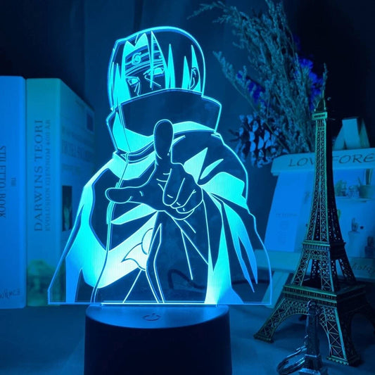 <img src="LED lamp featuring an outline illustration of Itachi Uchiha from Naruto and Naruto Shippuden during his time with the Akatsuki. He is depicted wearing the iconic Akatsuki cloak with a serious expression, pointing forward. The warm orange light highlights his headband and cloak, capturing his intense presence as a member of the Akatsuki.">