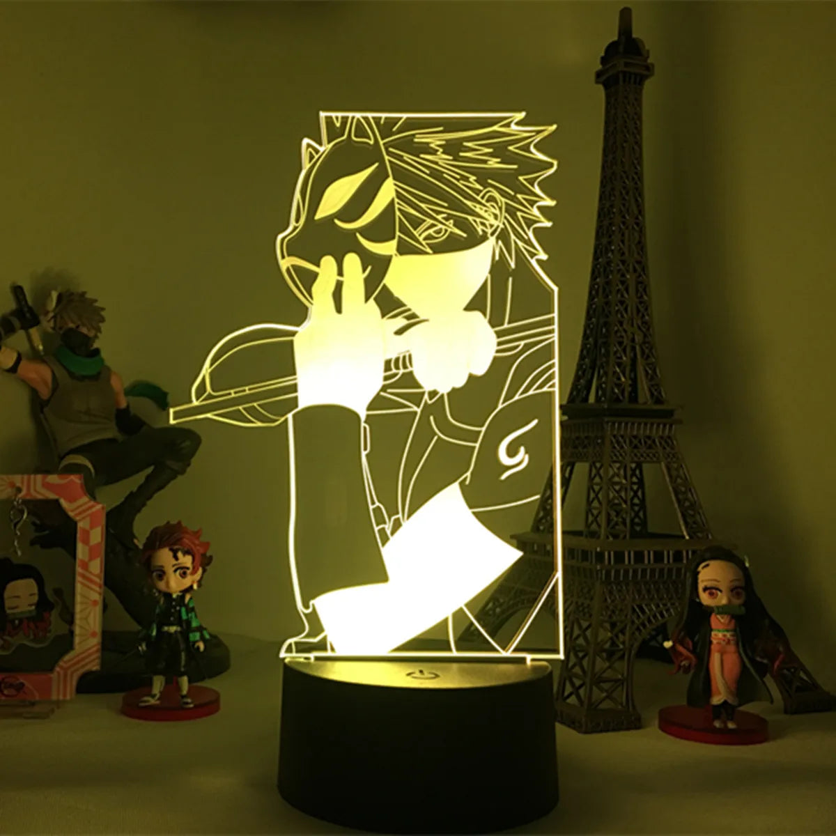 <img src="nightlight-kakashi-anbu.jpg" alt="Naruto LED night light featuring Kakashi Hatake in his Anbu Black attire from Naruto Shippuden. This unique anime lamp emits a warm amber glow, showcasing Kakashi’s iconic mask and sword, perfect for creating an atmospheric decor for Naruto fans. Ideal as an anime gift or collectible, adding character to any room.">